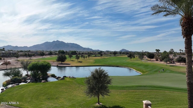 view of home's community featuring a water and mountain view, a lawn, and view of golf course