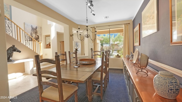 dining area with stairs, rail lighting, and visible vents