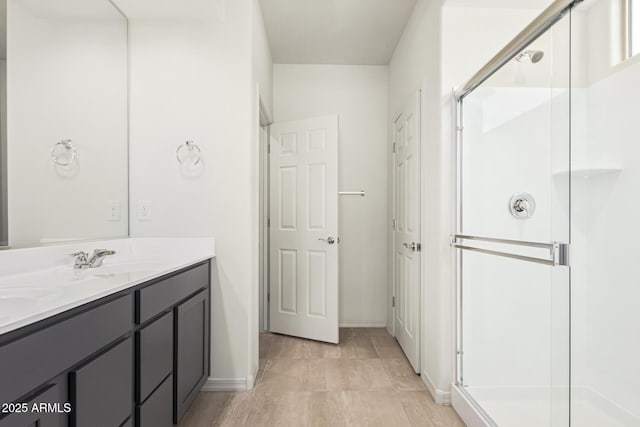 bathroom featuring vanity and an enclosed shower