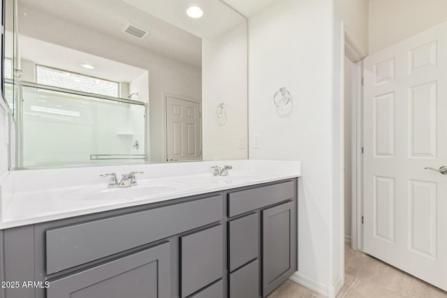 bathroom featuring vanity, an enclosed shower, and tile patterned floors