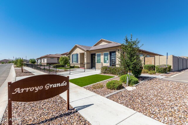 ranch-style house featuring fence, stucco siding, and a residential view