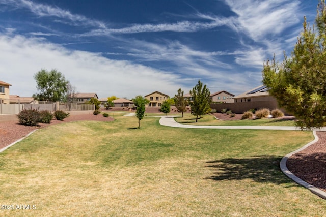 view of yard featuring fence and a residential view