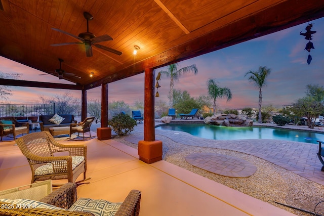 patio terrace at dusk featuring an outdoor hangout area