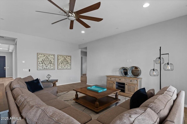 living area with recessed lighting, baseboards, a ceiling fan, and wood finished floors