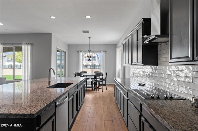 kitchen featuring black electric stovetop, a sink, decorative backsplash, dishwasher, and wall chimney range hood