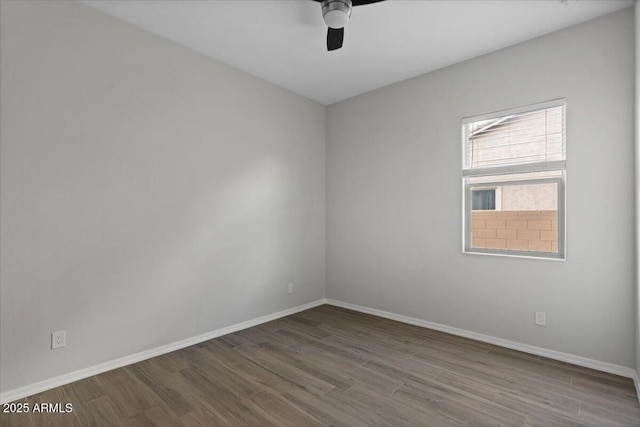 unfurnished room featuring baseboards, wood finished floors, and a ceiling fan