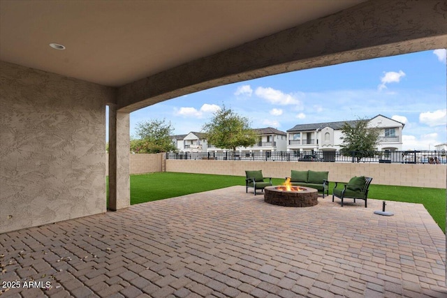 view of patio / terrace featuring a residential view, an outdoor fire pit, and a fenced backyard