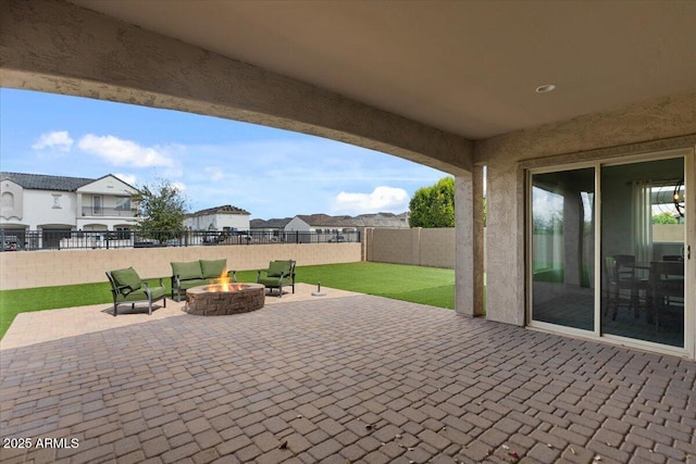 view of patio featuring a residential view, a fire pit, and a fenced backyard