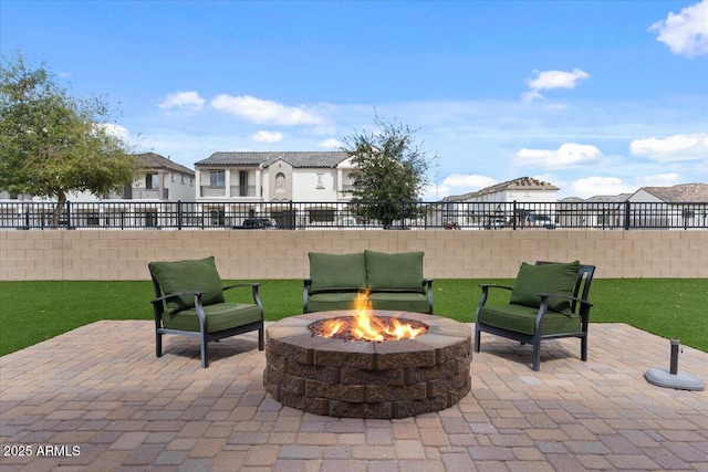 view of patio featuring fence and a fire pit