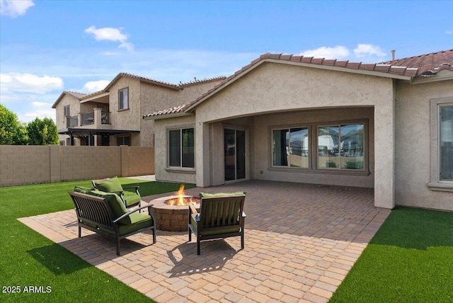 view of patio featuring an outdoor fire pit and fence