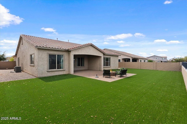 back of property with a tiled roof, a patio area, a fenced backyard, and stucco siding