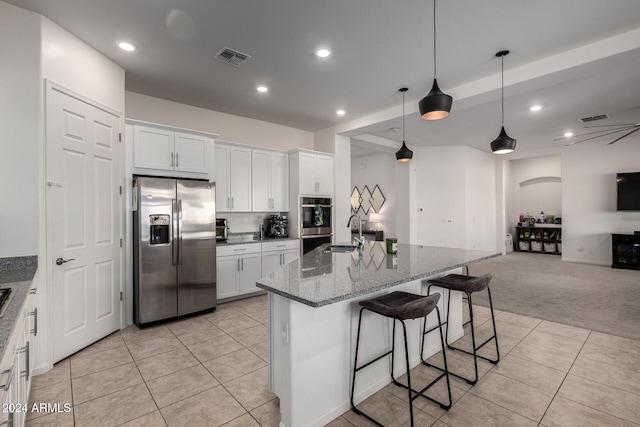 kitchen with white cabinets, sink, light colored carpet, and stainless steel appliances