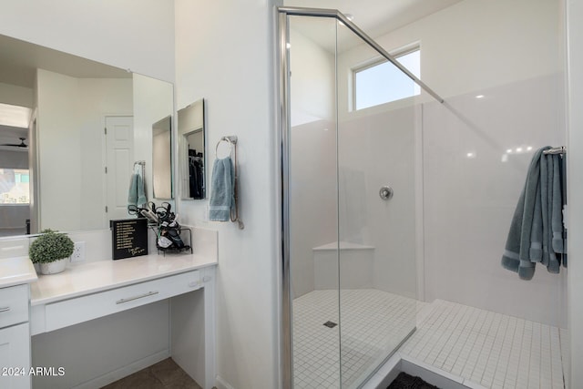 bathroom with tile patterned floors, vanity, and a shower with shower door