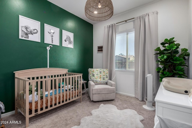 carpeted bedroom featuring a crib