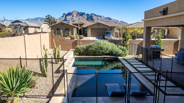 view of swimming pool featuring grilling area and a mountain view