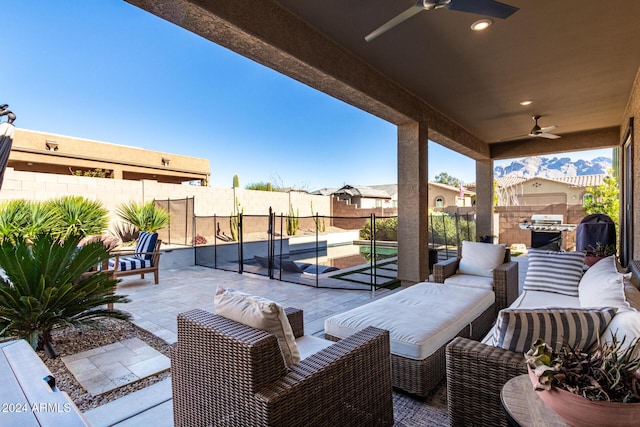 view of patio / terrace featuring a grill, ceiling fan, a swimming pool, and outdoor lounge area