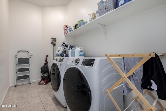 washroom with light tile patterned floors and independent washer and dryer