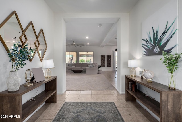 corridor with beam ceiling and light colored carpet