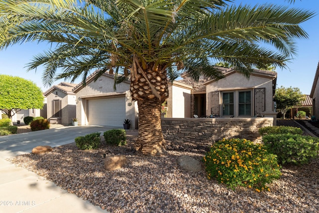 4550 E Donato Dr, Gilbert, AZ 85298 - view of front of house featuring an attached garage, driveway, stucco siding, and stone siding