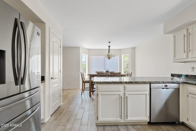 706 N El Dorado Dr, Gilbert, AZ 85233 - kitchen with appliances with stainless steel finishes, a peninsula, white cabinetry, and light wood-type flooring