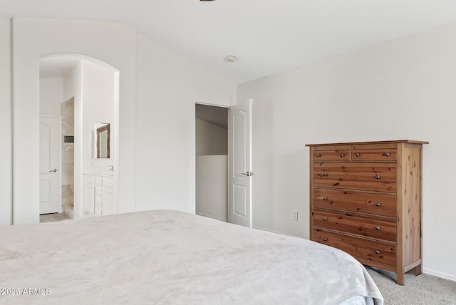 706 N El Dorado Dr, Gilbert, AZ 85233 - bedroom featuring vaulted ceiling, light carpet, ensuite bath, and baseboards