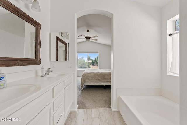 706 N El Dorado Dr, Gilbert, AZ 85233 - ensuite bathroom with double vanity, a garden tub, vaulted ceiling, and a ceiling fan