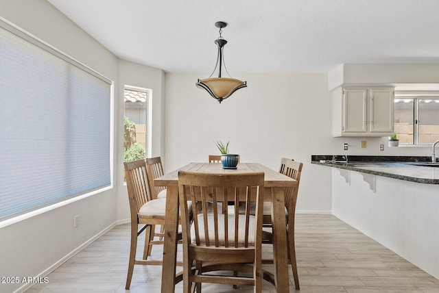 706 N El Dorado Dr, Gilbert, AZ 85233 - dining area with light wood-type flooring, plenty of natural light, and baseboards