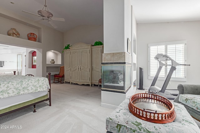 bedroom with ceiling fan, light colored carpet, and high vaulted ceiling