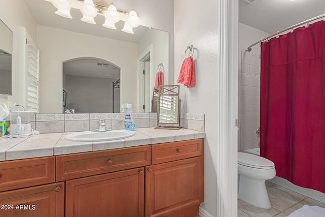 bathroom with vanity, tile patterned flooring, and toilet