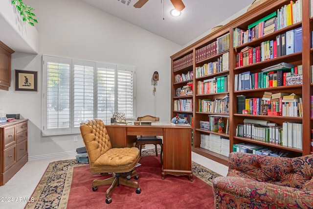 carpeted office featuring vaulted ceiling and ceiling fan