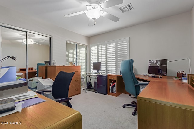 carpeted home office with ceiling fan