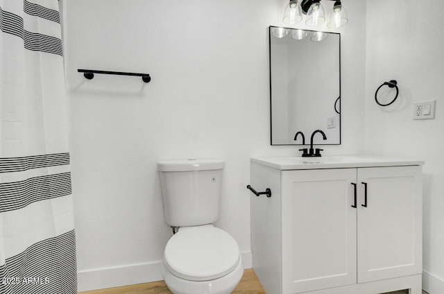 bathroom with vanity, toilet, and curtained shower