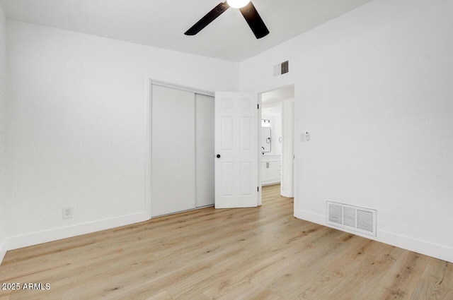 unfurnished bedroom featuring a closet, ceiling fan, and light hardwood / wood-style flooring