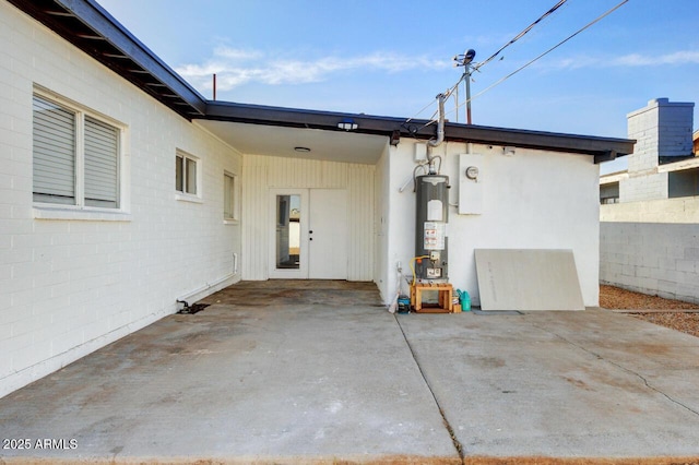 exterior space featuring a patio area and gas water heater