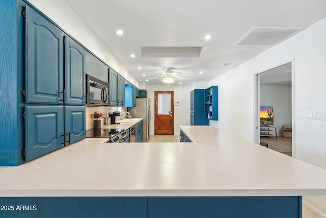 8135 N 5th St, Phoenix, AZ 85020 - kitchen with stainless steel appliances, light countertops, a ceiling fan, recessed lighting, and blue cabinetry