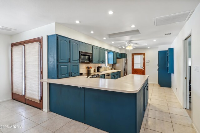 8135 N 5th St, Phoenix, AZ 85020 - kitchen featuring stainless steel appliances, light countertops, a sink, light tile patterned floors, and recessed lighting