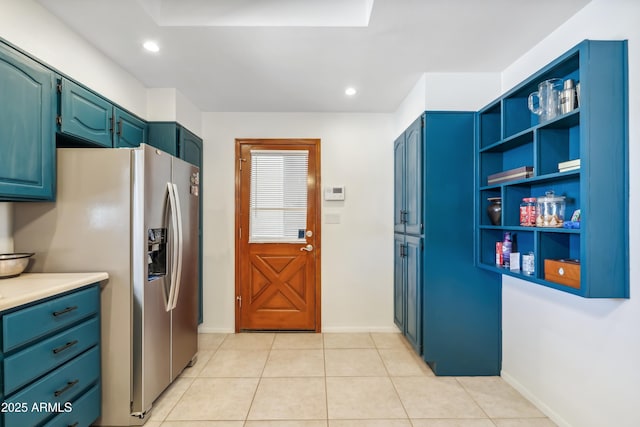8135 N 5th St, Phoenix, AZ 85020 - kitchen featuring stainless steel fridge with ice dispenser, light countertops, open shelves, blue cabinetry, and light tile patterned flooring