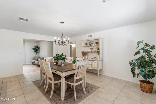 8135 N 5th St, Phoenix, AZ 85020 - dining space featuring light tile patterned floors, a chandelier, and baseboards