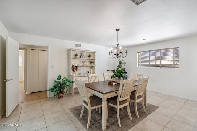 8135 N 5th St, Phoenix, AZ 85020 - dining area featuring a chandelier, light tile patterned floors, and baseboards