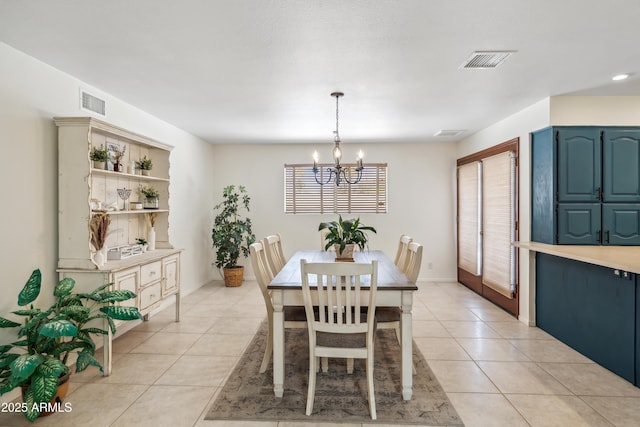8135 N 5th St, Phoenix, AZ 85020 - dining room featuring a chandelier, light tile patterned floors, and baseboards