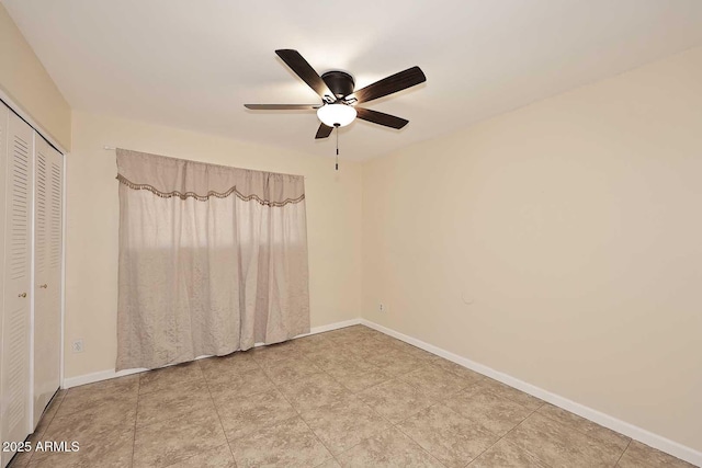 unfurnished bedroom with a closet, ceiling fan, and baseboards