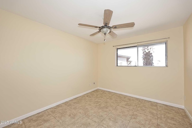 spare room featuring light tile patterned floors, ceiling fan, and baseboards