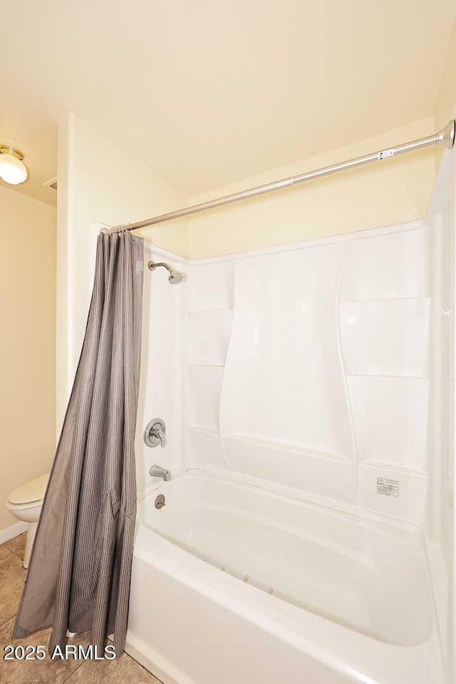 full bathroom with tile patterned flooring, shower / tub combo, and toilet