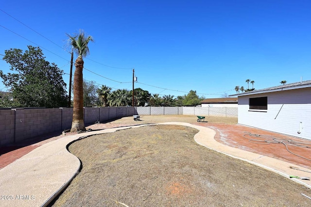 view of yard featuring a patio area and a fenced backyard