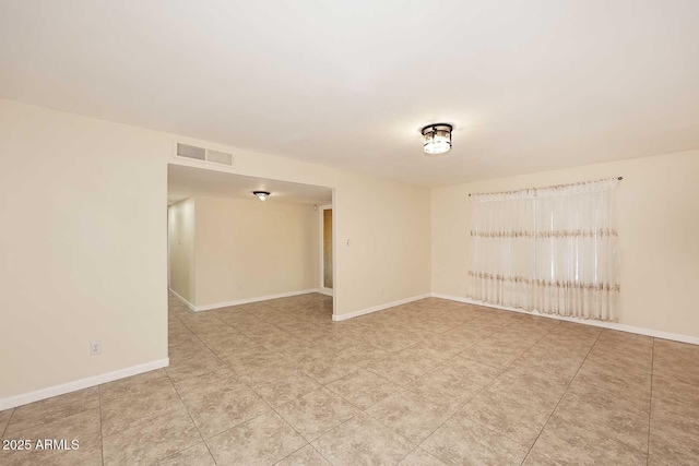 empty room with visible vents and baseboards