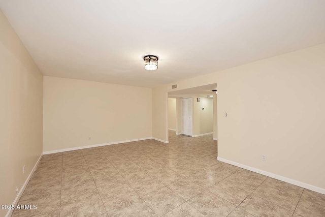 spare room featuring visible vents and baseboards