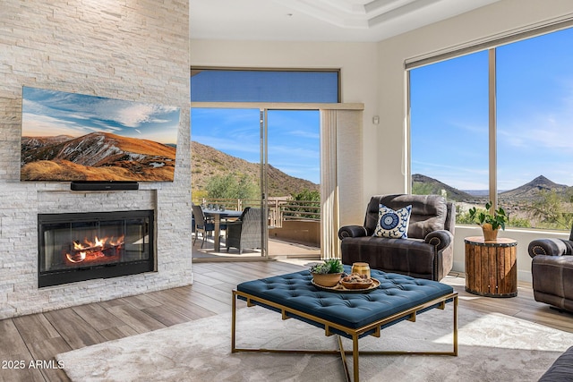 13621 E Aster Dr, Scottsdale, AZ 85259 - living room featuring a fireplace, a mountain view, and wood finished floors
