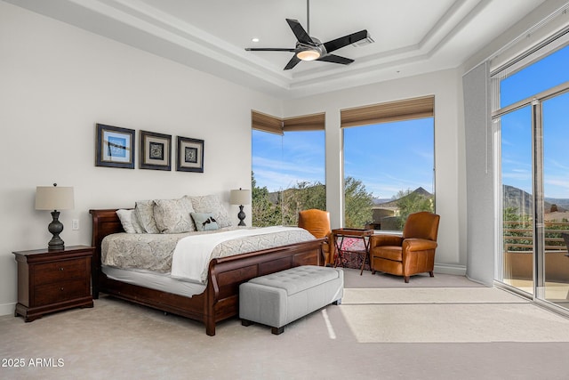 13621 E Aster Dr, Scottsdale, AZ 85259 - bedroom featuring multiple windows, a ceiling fan, a tray ceiling, and access to exterior