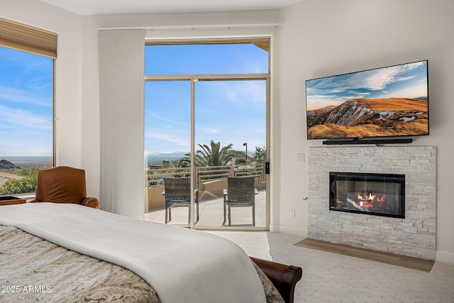 13621 E Aster Dr, Scottsdale, AZ 85259 - bedroom featuring multiple windows, carpet, and a stone fireplace