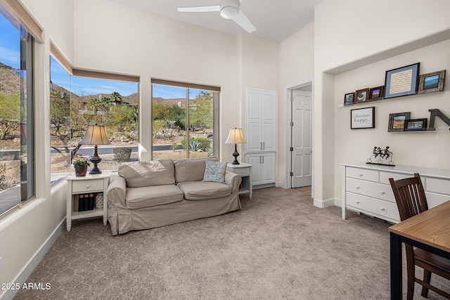 13621 E Aster Dr, Scottsdale, AZ 85259 - carpeted living area featuring a ceiling fan, a towering ceiling, and baseboards